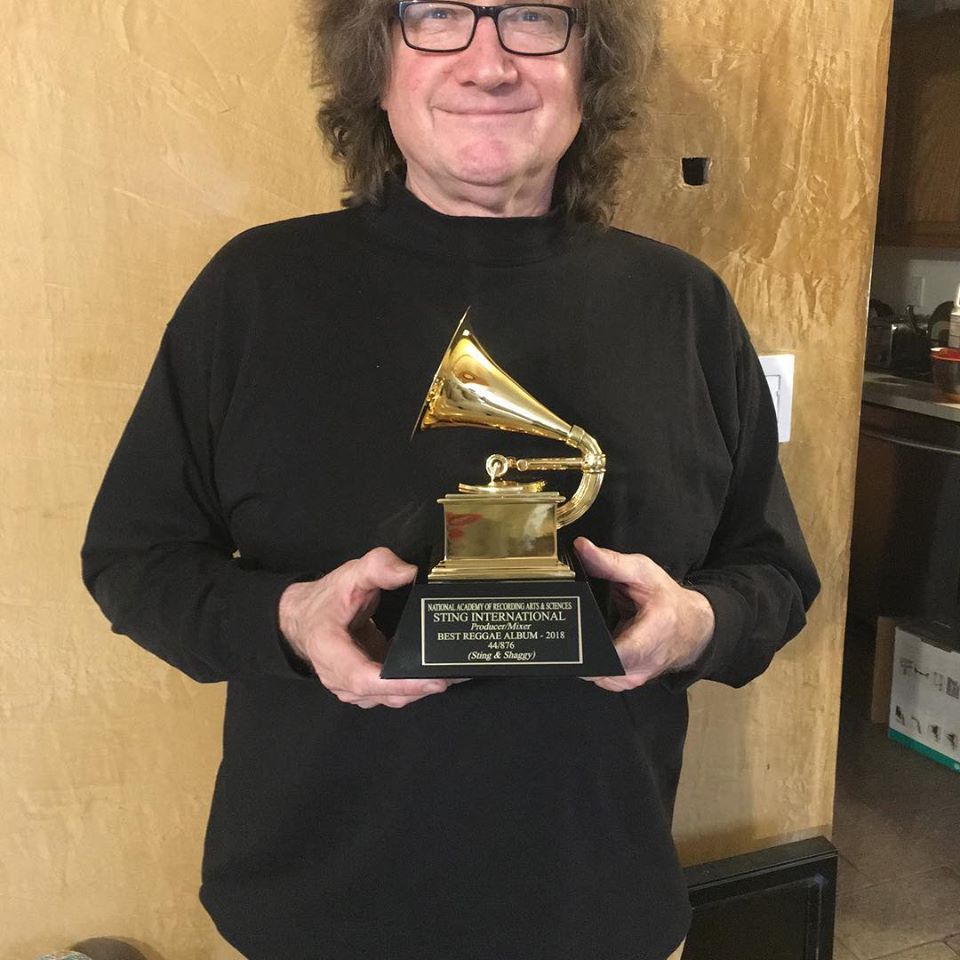 Andy Bassford from Island Head reggae musicians holding the grammy for the recording of the reggae album of the year Sting & Shaggy 44/876
